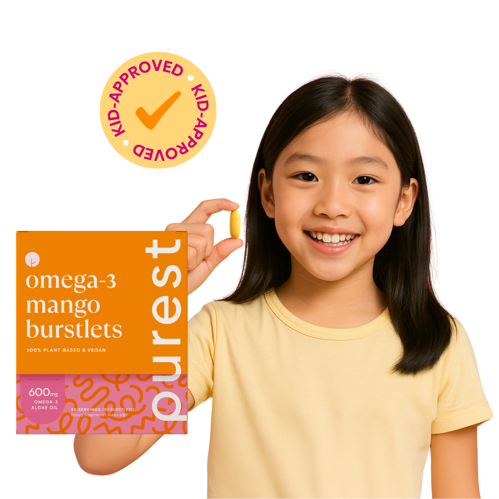 Child holding a single Purest Kids omega-3 burstlet with product box — kid-approved, 100% plant-based and vegan
